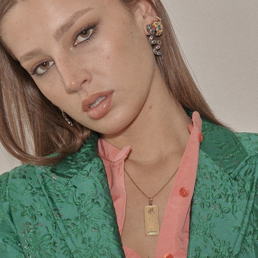 Green brocade jacket with the gold Good Times Tablet necklace