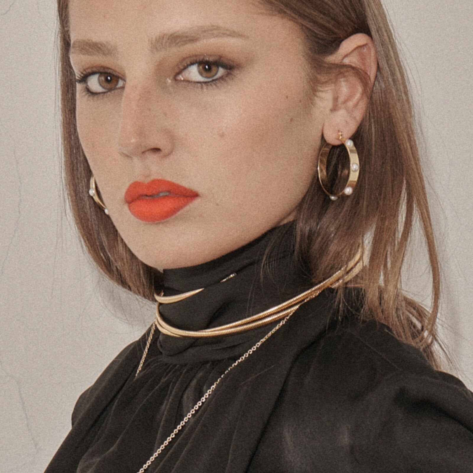 Gold hoops and a stacked collar, from the Basic Instinct look